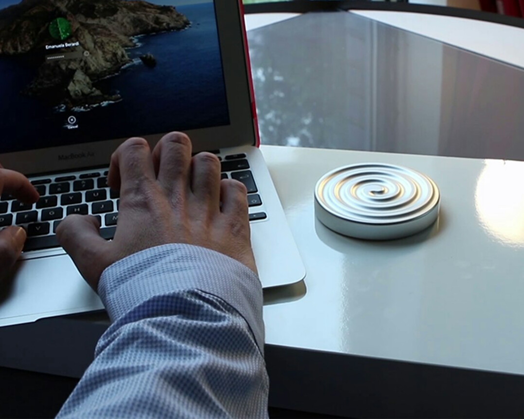 Hands typing on a laptop displaying a live signal monitoring dashboard